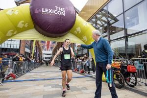 James Sunderland presents medals to runners in the Bracknell Half Marathon