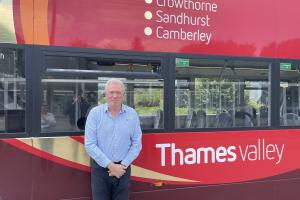 James Sunderland MP standing in front of a Thames Valley bus